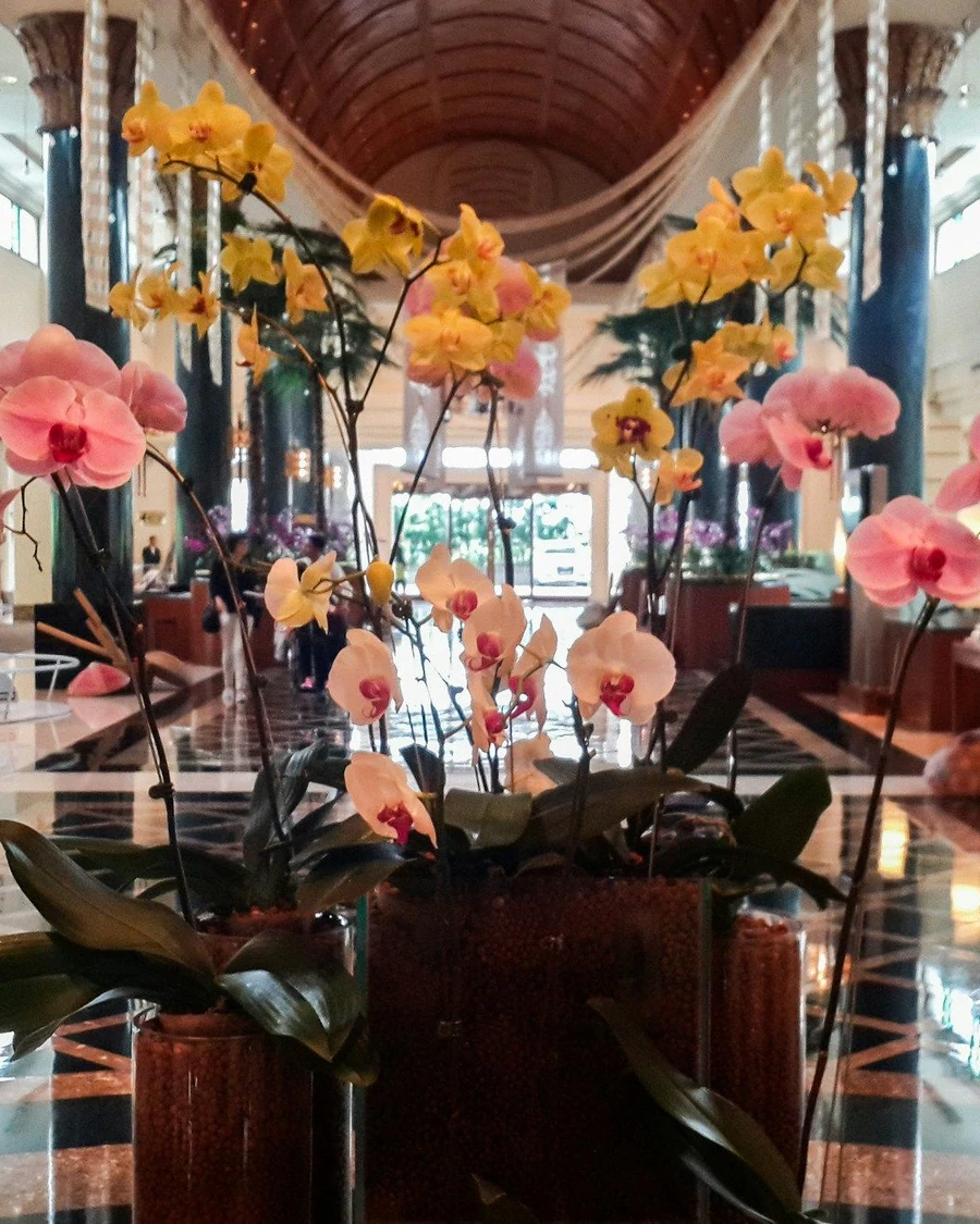 Floral arrangement in the marble lobby of an upscale hotel.